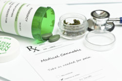 Medical marijuana prescription with bottle and stethoscope.