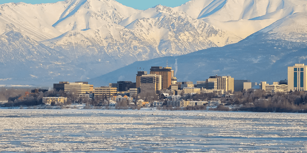 Anchorage, Alaska waterfront scene with snowy mountains in the background.