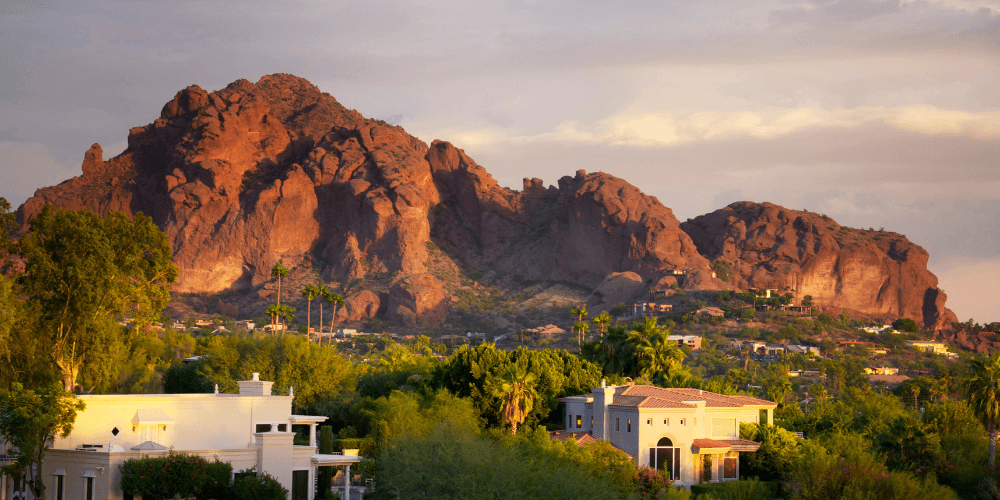 Iconic Camelback Mountain in Scottsdale, AZ, towering over the desert landscape under a clear blue sky.